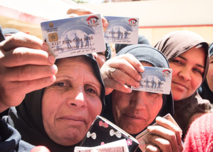 Egyptian Women hold the cash transfer cards.